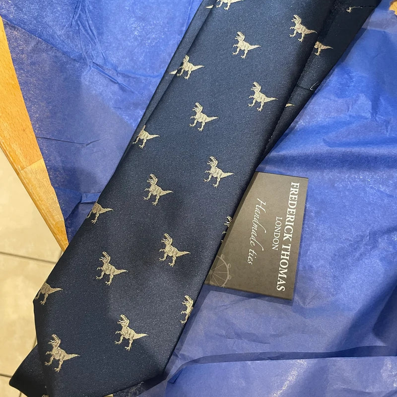 Navy blue tie embroidered with T-rex dinosaur